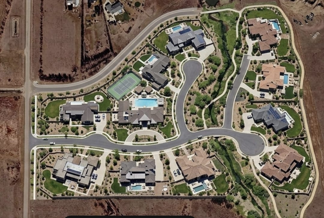 Aerial view of estate homes and greenery at Aparche